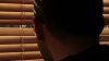 stock-footage-man-looking-through-blinds.jpg